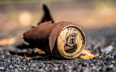 Close-up of rusty and can of coke