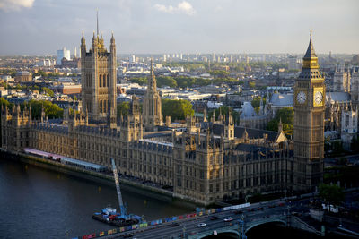 Westminster palace and bridge by thames river in city