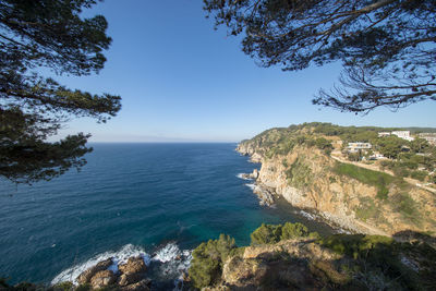 Scenic view of sea against clear blue sky