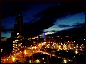 Cityscape against cloudy sky at dusk