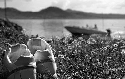 Close-up of shoes on the beach