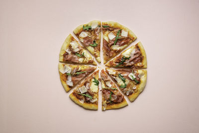 Directly above shot of pizza against white background