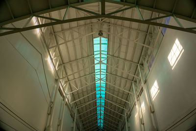 Low angle view of illuminated lights hanging on ceiling in building