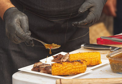 Midsection of man preparing food on table