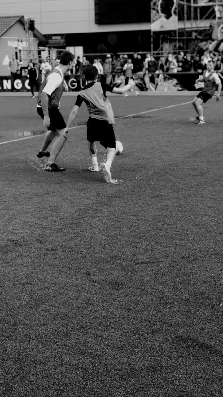 GROUP OF PEOPLE PLAYING SOCCER