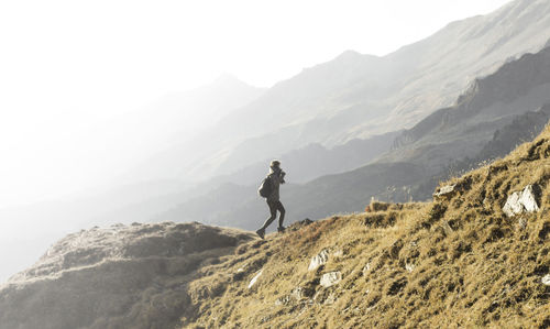 Man standing on mountain against sky