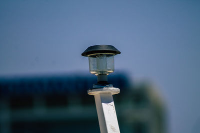 Close-up of illuminated lamp against clear sky