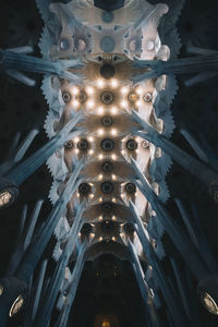 Low angle view of illuminated ceiling in temple