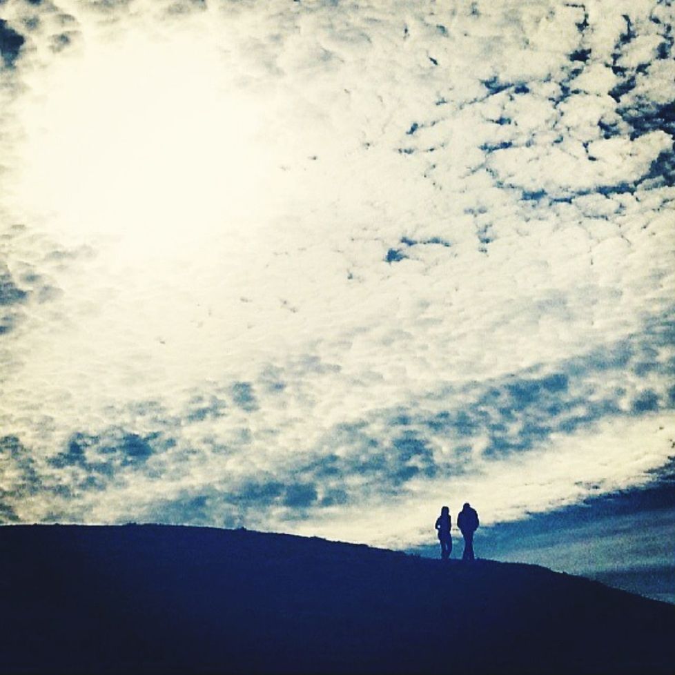 SILHOUETTE WOMAN STANDING ON MOUNTAIN AGAINST SKY