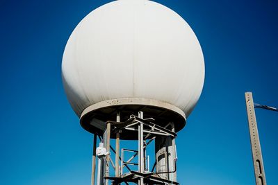 Low angle view of built structure against clear blue sky