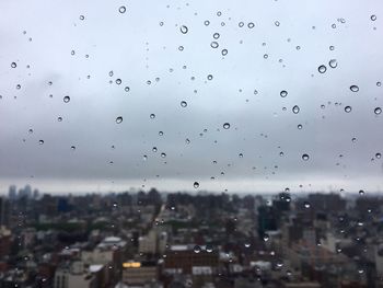 Close-up of wet window in city