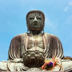 Statue of buddha against blue sky