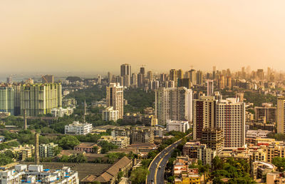 High angle view of modern buildings in city against clear sky