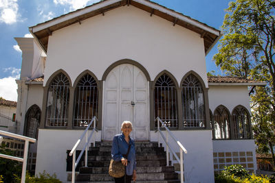 Rear view of woman standing in front of church