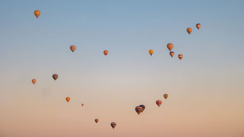Low angle view of balloons flying against clear sky