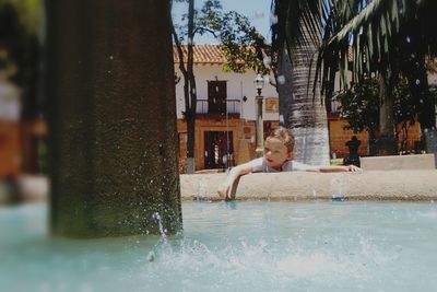 Portrait of shirtless man in swimming pool