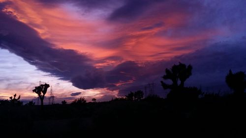 Silhouette of landscape against cloudy sky