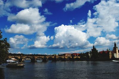 View of bridge over river against cloudy sky