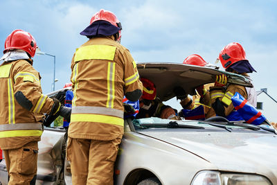 Firefighters during a rescue operation training in broken car