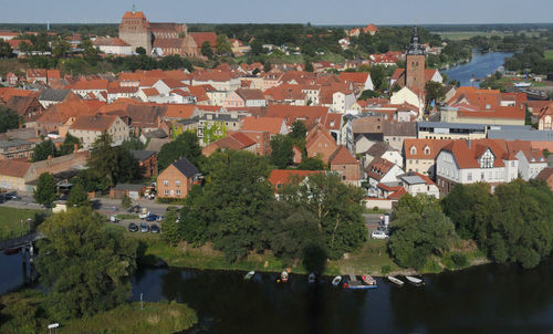 High angle view of townscape by river in city