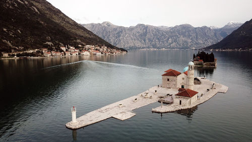 Scenic view of lake by mountains against sky