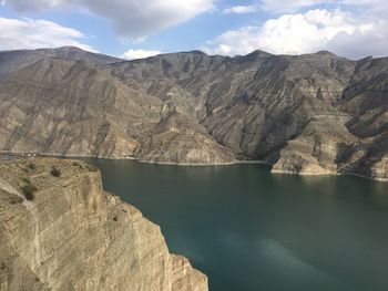 Scenic view of mountains against cloudy sky