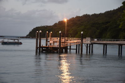 Pier on river against sky