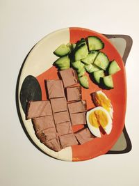 High angle view of chopped vegetables on table against white background