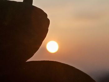 Silhouette rock against sky during sunset