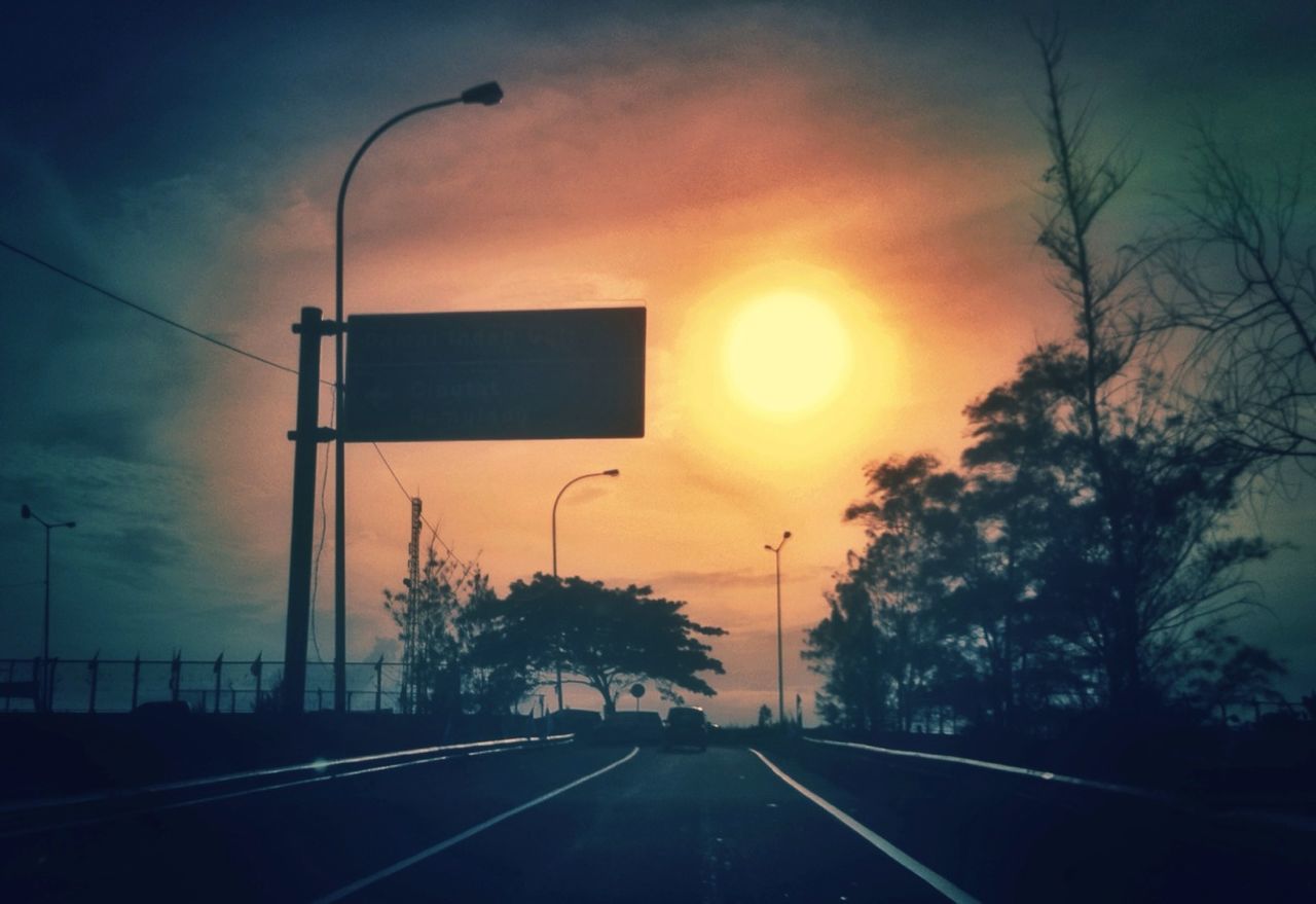 transportation, sunset, road, the way forward, sky, street light, silhouette, diminishing perspective, tree, road marking, street, vanishing point, empty road, cloud - sky, power line, road sign, electricity pylon, dusk, nature, outdoors