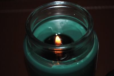 High angle view of lit candle in jar