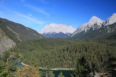 Scenic view of mountains against blue sky