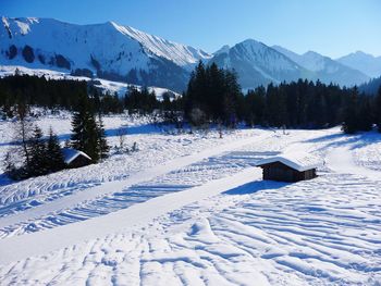 Scenic view of snow covered mountains against sky