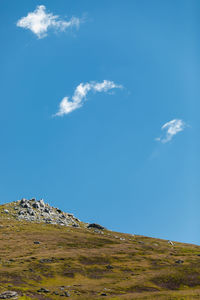 Low angle view of mountain against blue sky