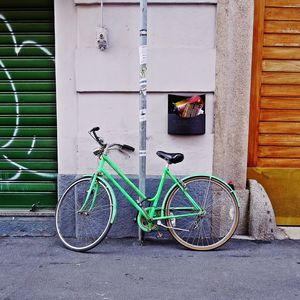 Bicycle parked against brick wall