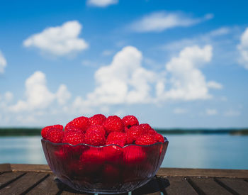 Raspberries on water against sky