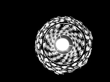 Low angle view of illuminated light bulb in darkroom