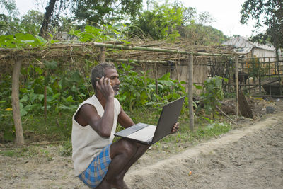 Full length of man using mobile phone