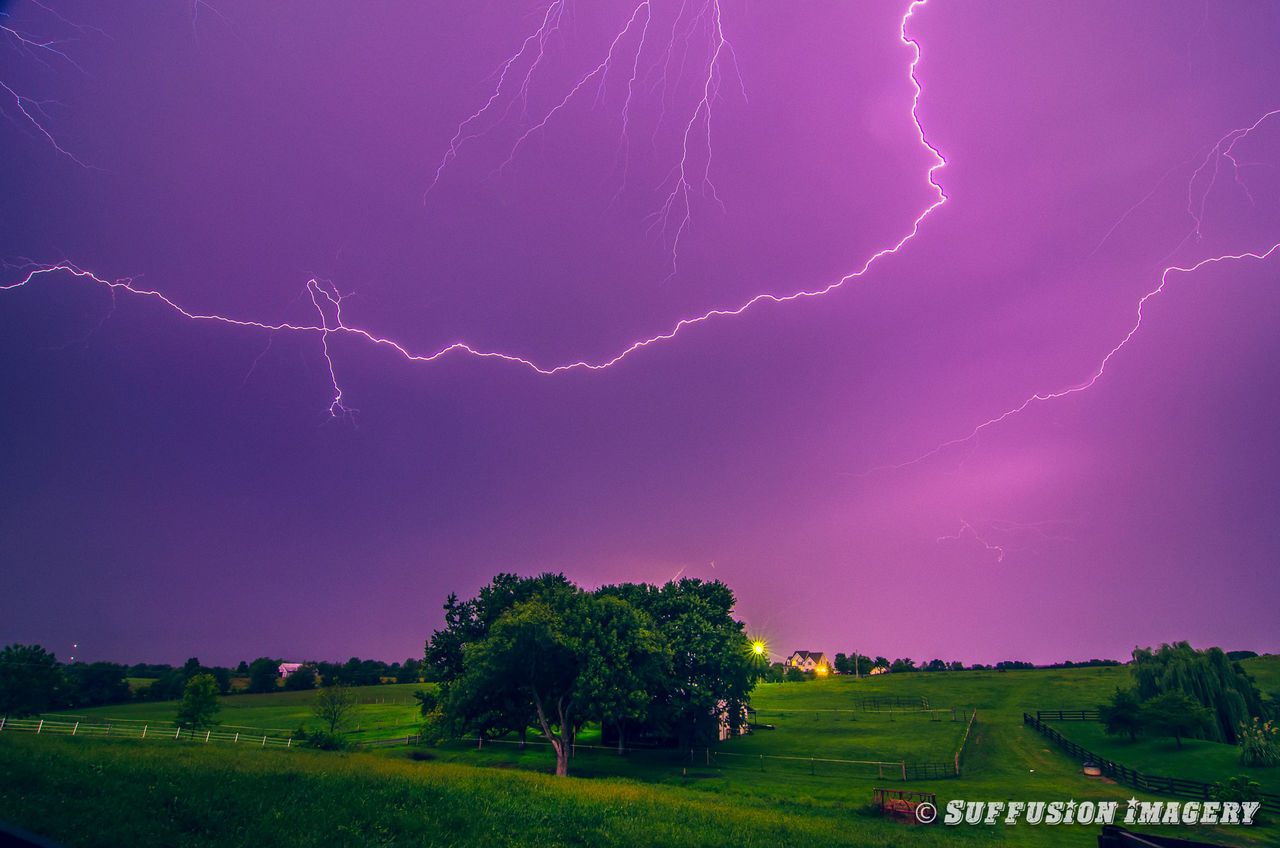 night, landscape, sky, illuminated, scenics, beauty in nature, field, tranquil scene, rainbow, tranquility, nature, tree, multi colored, thunderstorm, idyllic, long exposure, grass, outdoors, green color, lightning