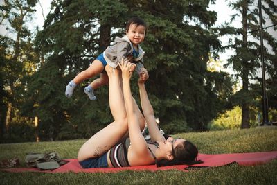 Full length of playful mother and son in park