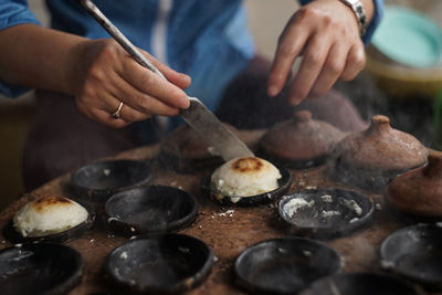 Midsection of person preparing food