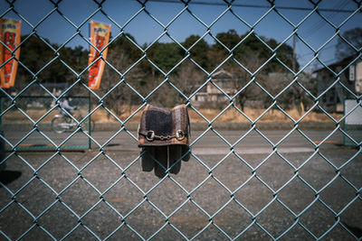 Close-up of glove on chainlink fence