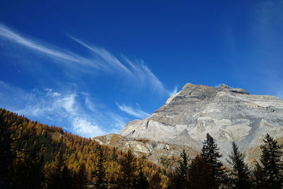 Low angle view of mountain against blue sky