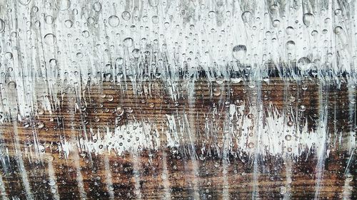 Full frame shot of raindrops on glass