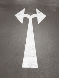 High angle view of arrow sign on road