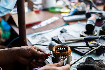 Cropped hands of man working on table