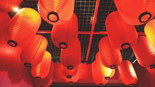 Low angle view of illuminated lanterns hanging on ceiling