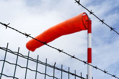 Low angle view of barbed wire against sky