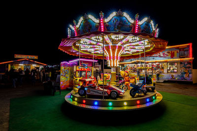 Illuminated ferris wheel at night