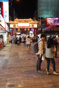 People on city street at night